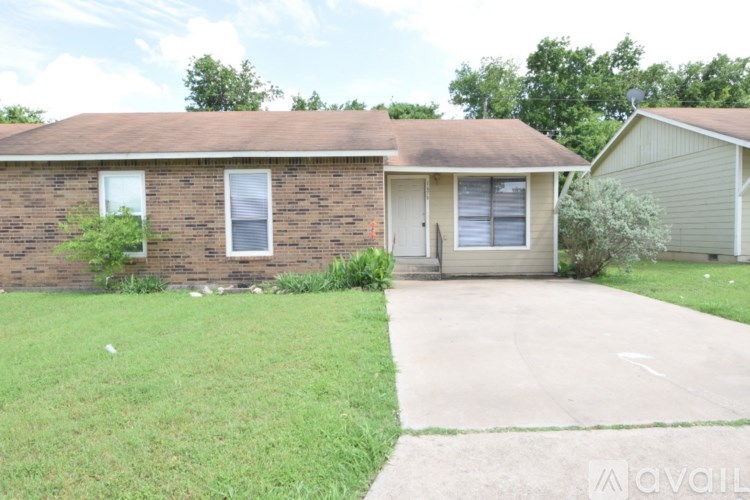 A house with a brown roof and a grey garage door.