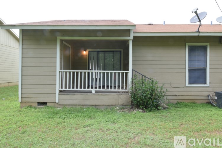 A house with a brown roof and a white porch.