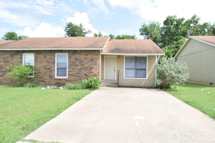 A house with a brown roof and a beige garage door.