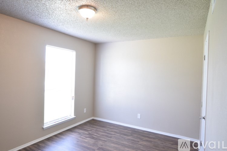 A room with a window and a door.