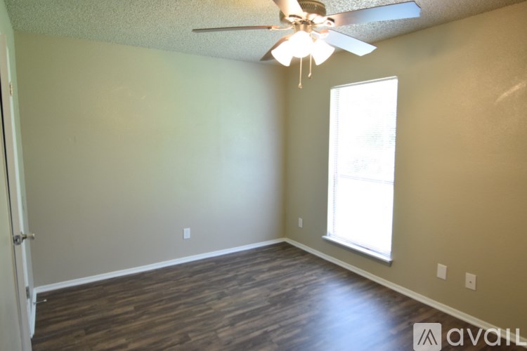 A room with a ceiling fan and a window.