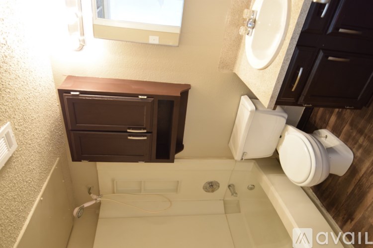 A bathroom with a toilet, sink, and bathtub.