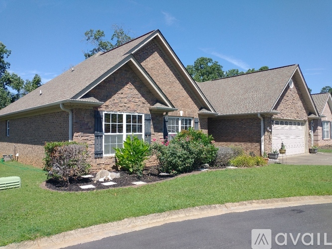 A house with a brown roof and a white garage door.