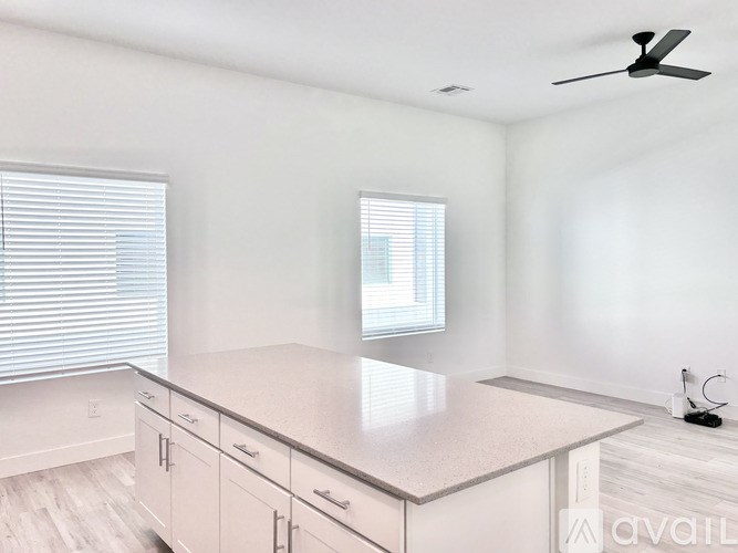 A kitchen with white cabinets and a countertop.