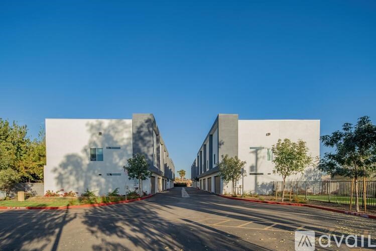 A modern building with a clear blue sky above it.