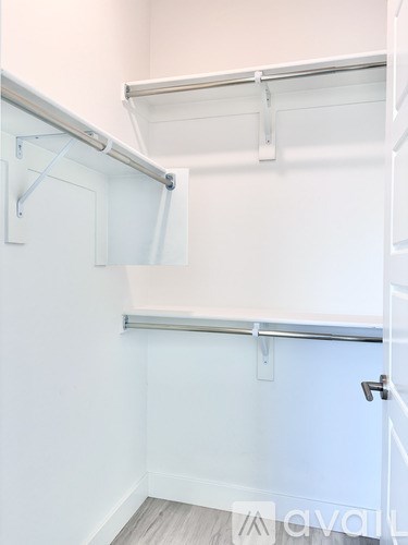 A white closet with a sliding door and shelves.