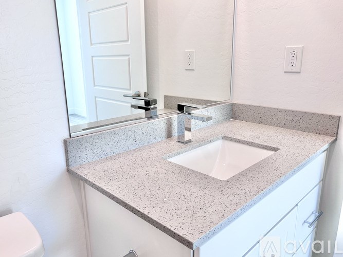 A bathroom with a sink and a toilet.