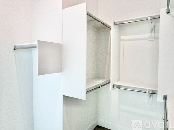 A white bathroom with a shower and a toilet.
