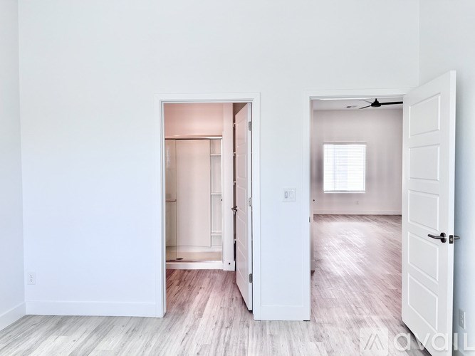 A room with a white door and a white wall.
