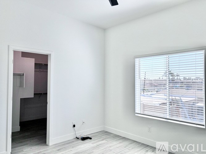 A room with a window and a door leading to another room.