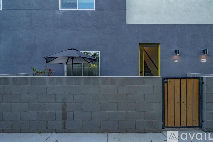 A building with a grey wall and a yellow door.