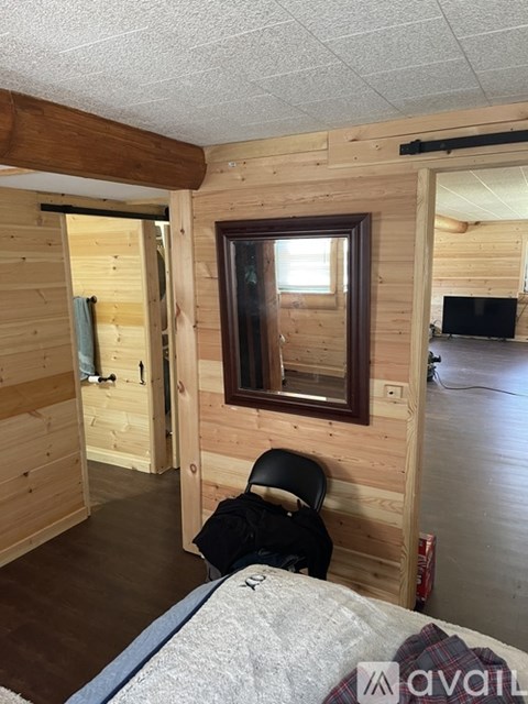A bedroom with a bed and a window.