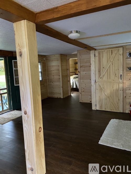 A room with wooden floors and a white ceiling with a light fixture.