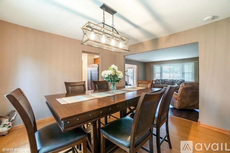 A dining room with a wooden table and chairs.