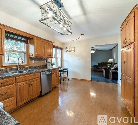 A kitchen with wooden cabinets and a large island.