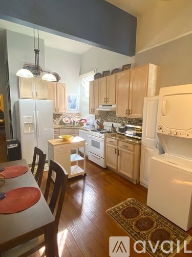 A kitchen with wooden cabinets and white appliances.