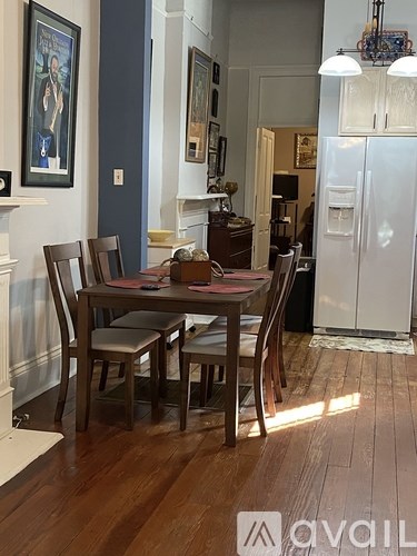 A dining room with a table set for four.