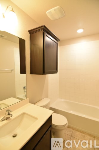 A bathroom with a toilet, sink, and bathtub.