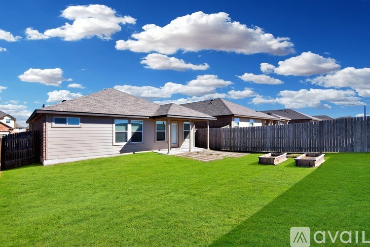 A house with a grey roof and a green lawn in front.