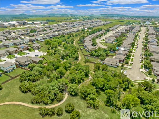 A bird's eye view of a residential area with houses and greenery.