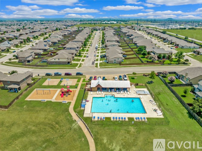 A bird's eye view of a residential area with a swimming pool and a playground.