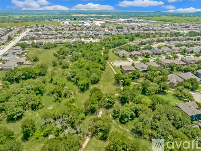 A bird's eye view of a residential area with houses and greenery.