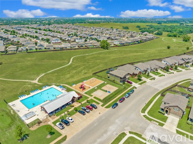 A bird's eye view of a residential area with a swimming pool and a playground.