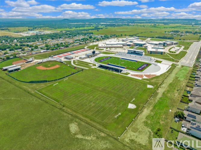 An aerial view of a school with a baseball field and a football field.