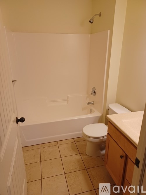 A bathroom with a toilet, sink, and bathtub.