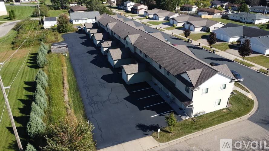 A large white building with a parking lot in front of it.