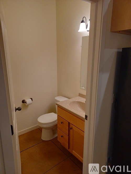 A white toilet sits in a small bathroom.
