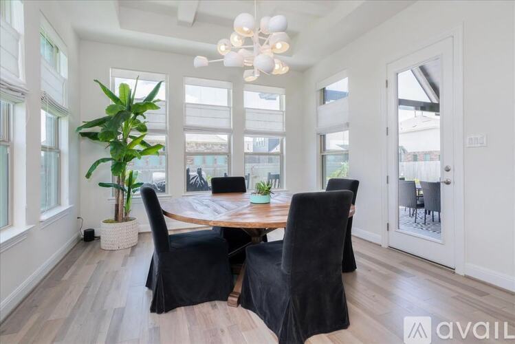 A dining room with a wooden table and chairs.