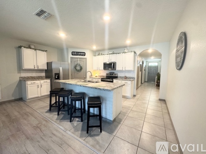 A kitchen with a bar area and a fridge.