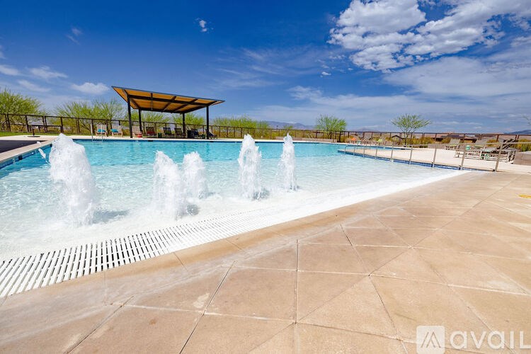 A pool with a fountain in the middle of it.