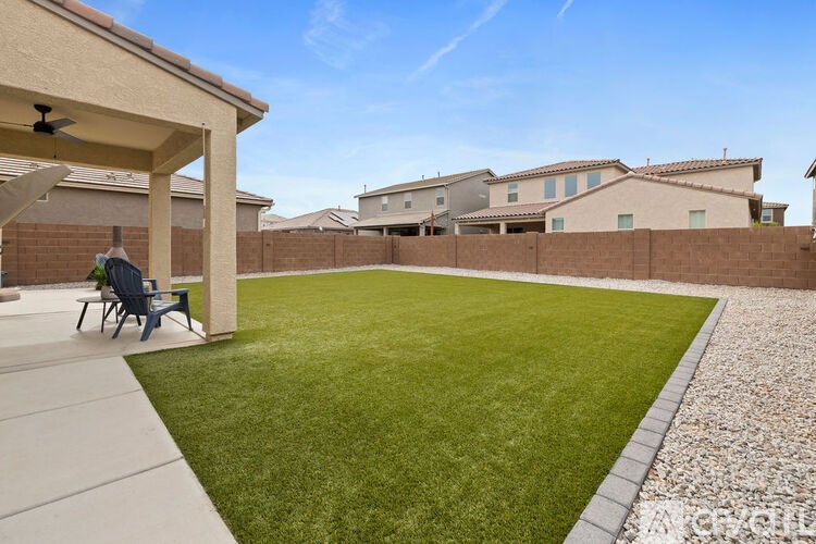 A backyard with a lawn and a patio area.