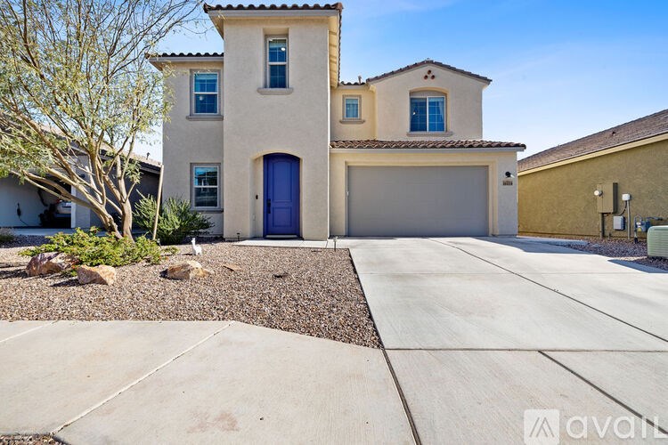 A house with a blue door and a garage.