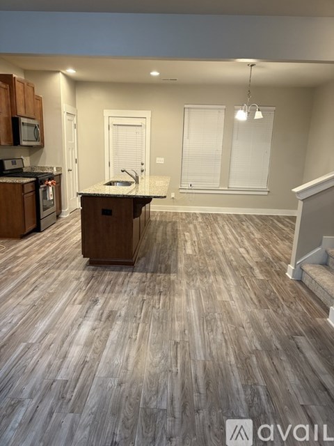 A kitchen with wooden floors and a countertop.