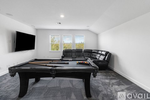 A modern dining room with a table set for four.