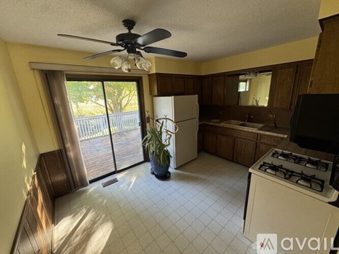 A kitchen with a white fridge and a white gas stove.