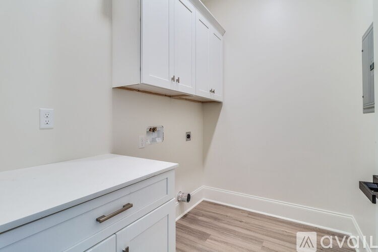 A kitchen with white cabinets and a white counter top.