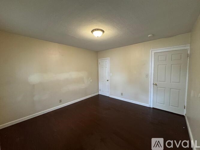 A room with two doors and a ceiling light.