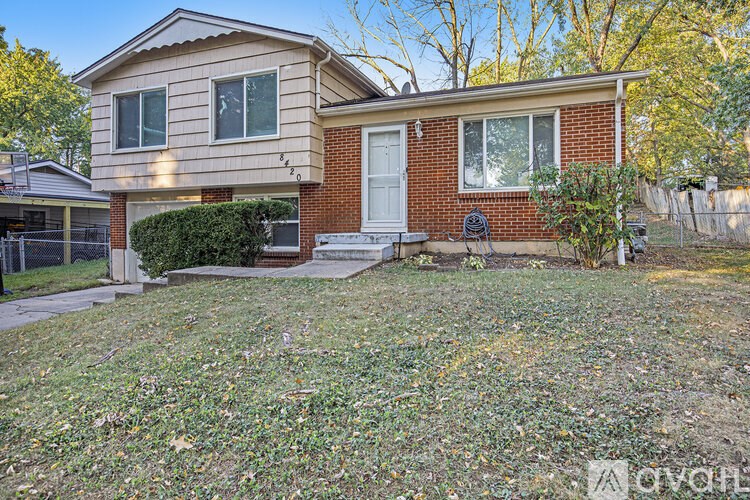 A house with a red brick exterior and a white door.