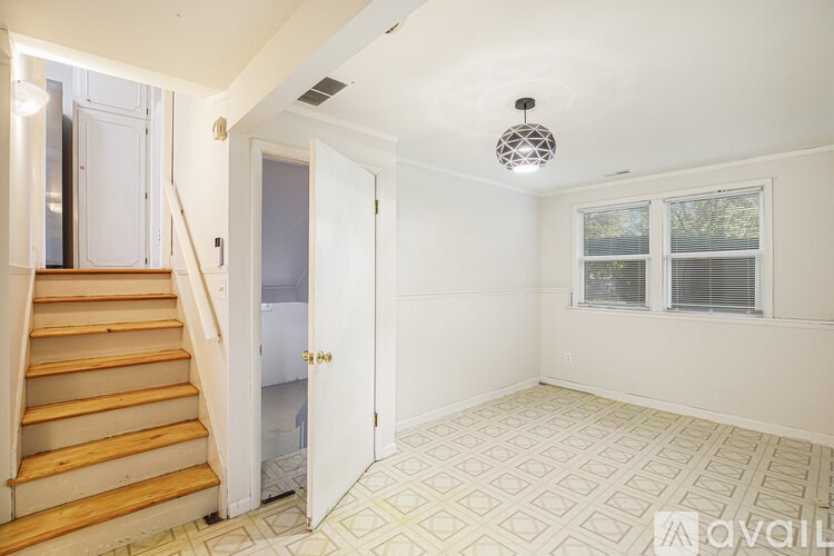 A room with a tiled floor and a window with blinds.