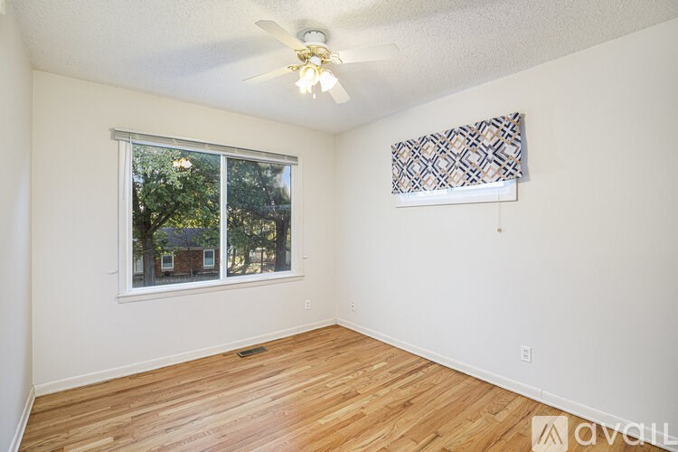 A room with a window and a ceiling fan.