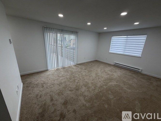 A bathroom with a toilet, sink, and mirror.