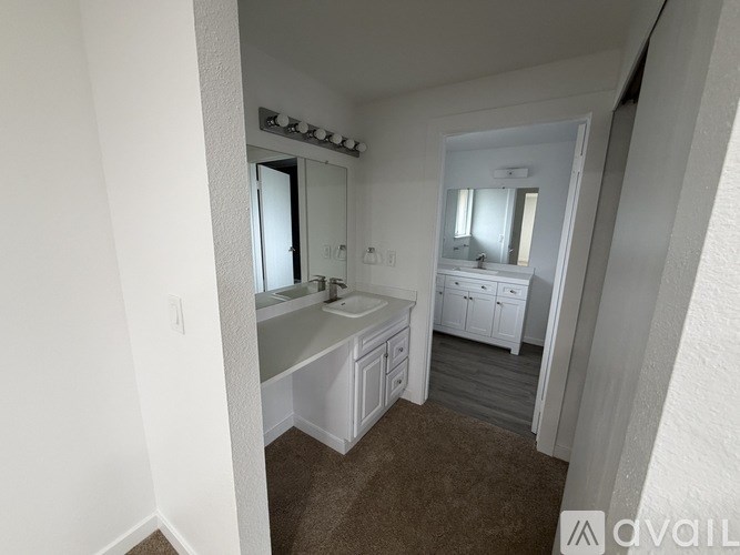 A room with a carpeted floor and a window letting in natural light.