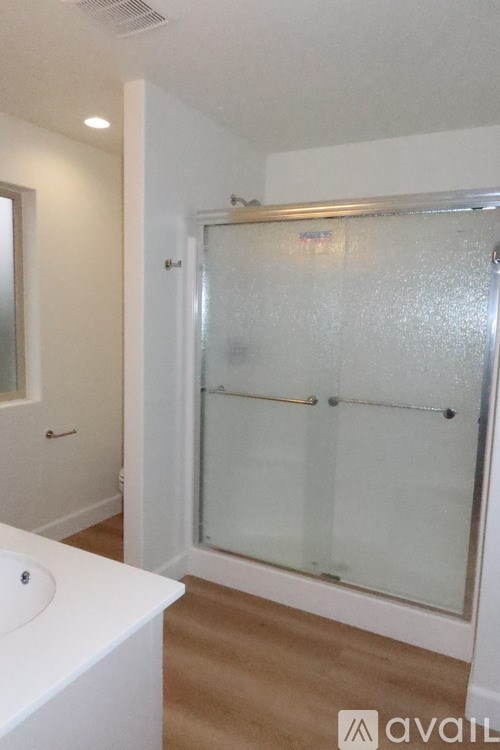 A room with a door, window, and carpet.