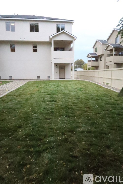 A room with wooden flooring and white walls.