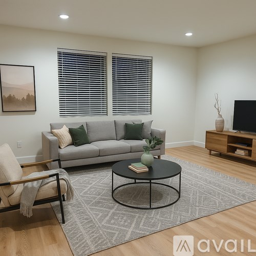 A kitchen with white cabinets and a window overlooking trees.