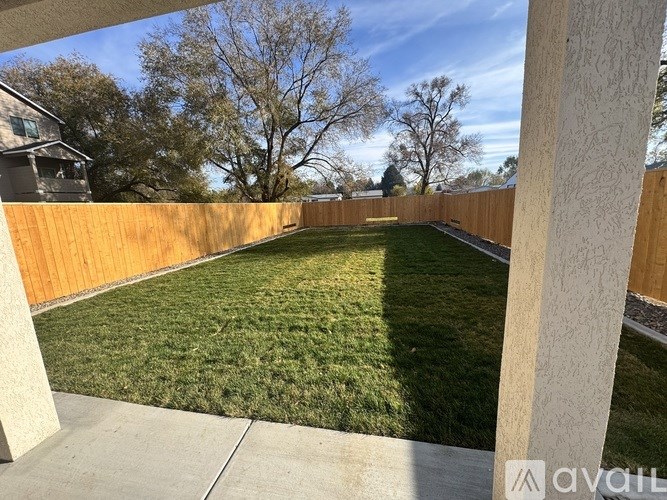 A room with wooden floors and a chandelier.